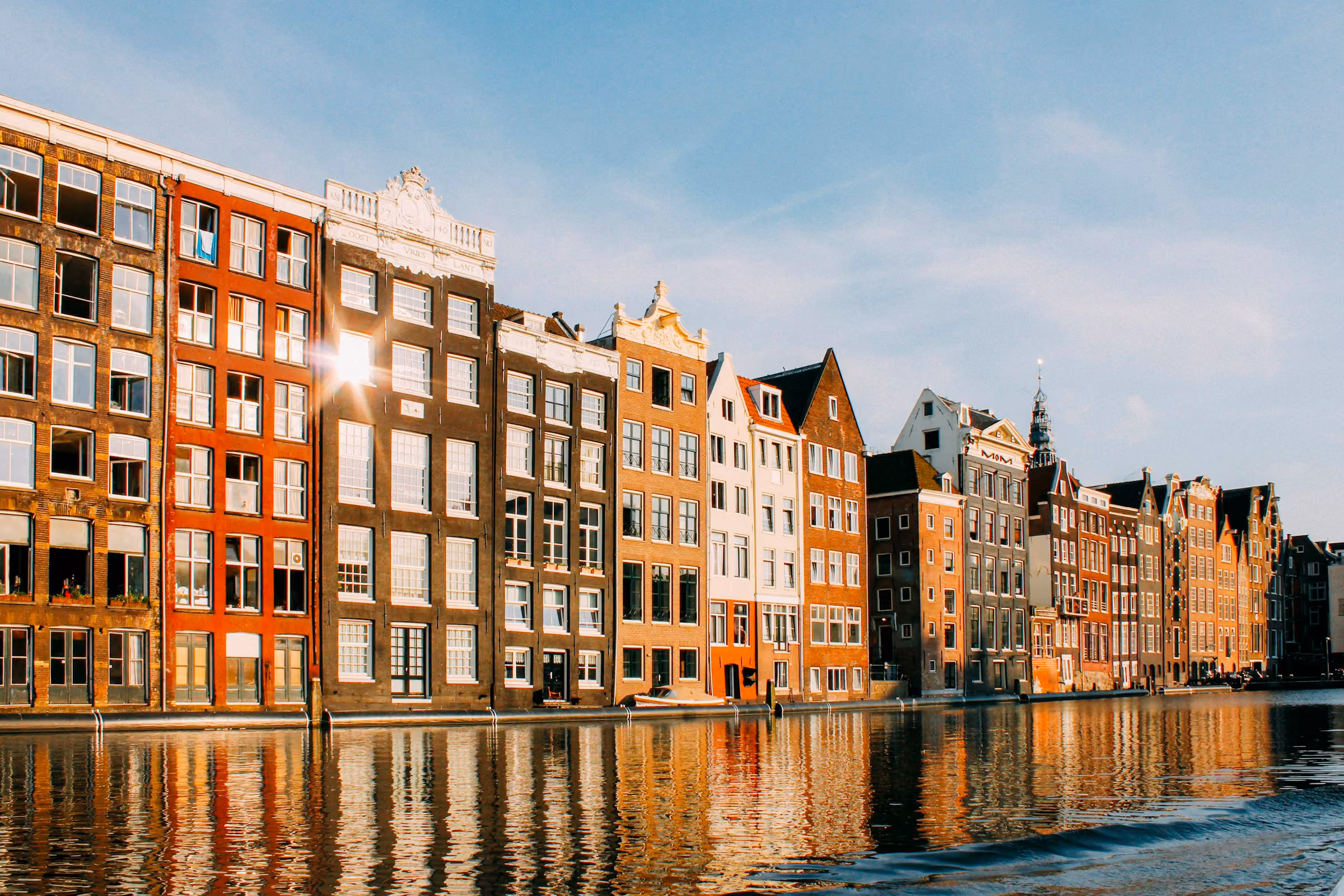 Gabled houses along an Amsterdam canal in late sun
