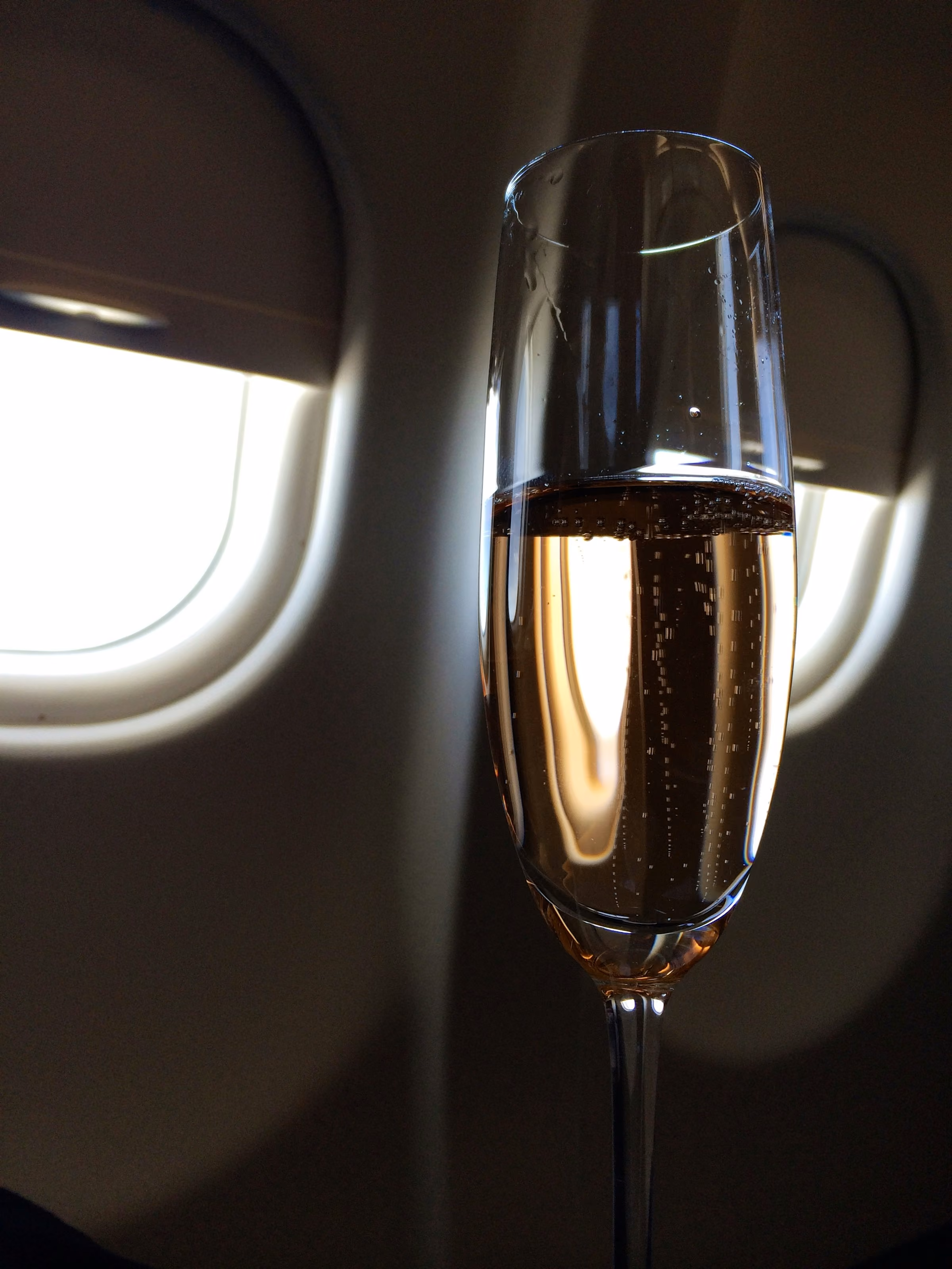 A glass of champagne on a table in summer light