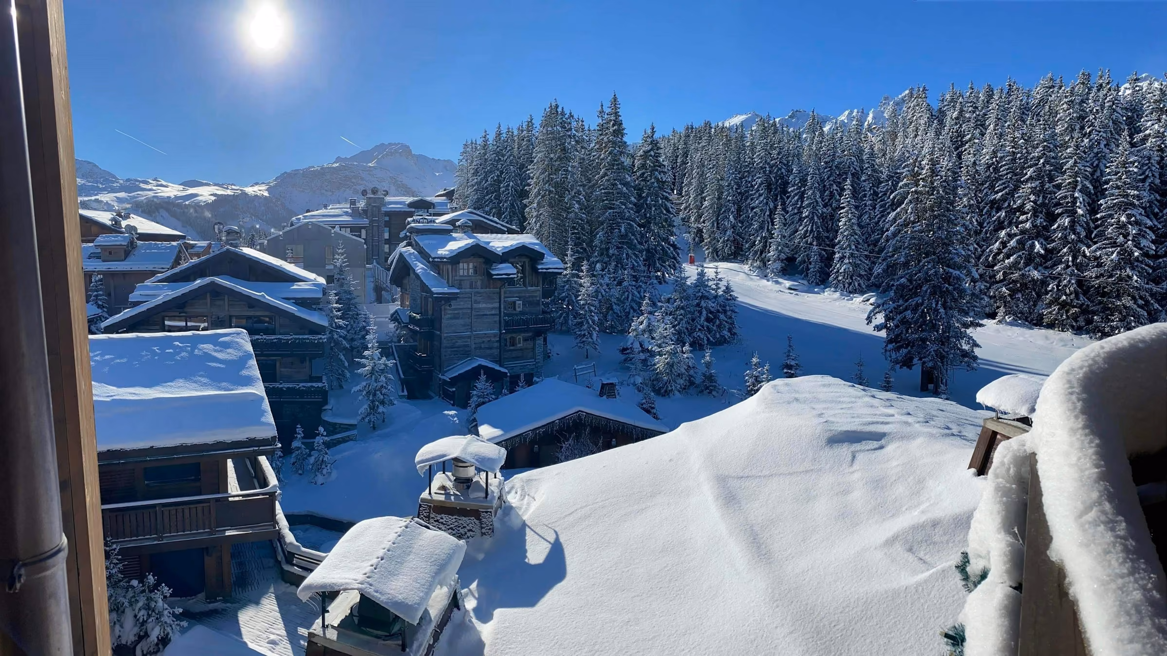 Snowy chalets and slopes in Courchevel on a sunny day