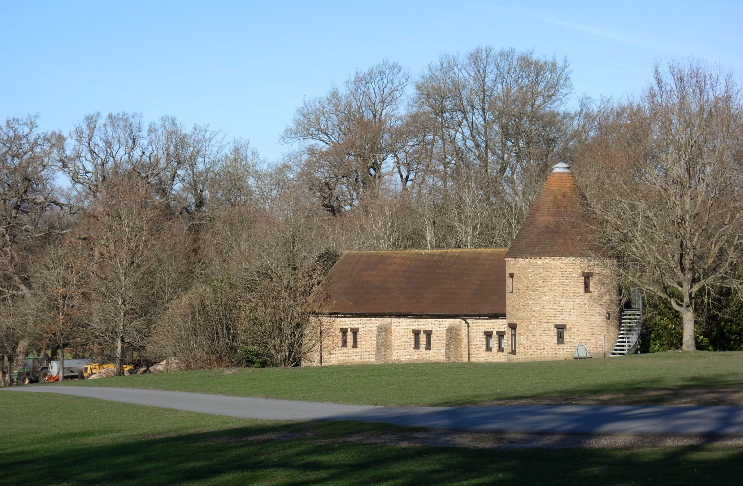 A brick and flint estate building in the grounds of Coworth Park