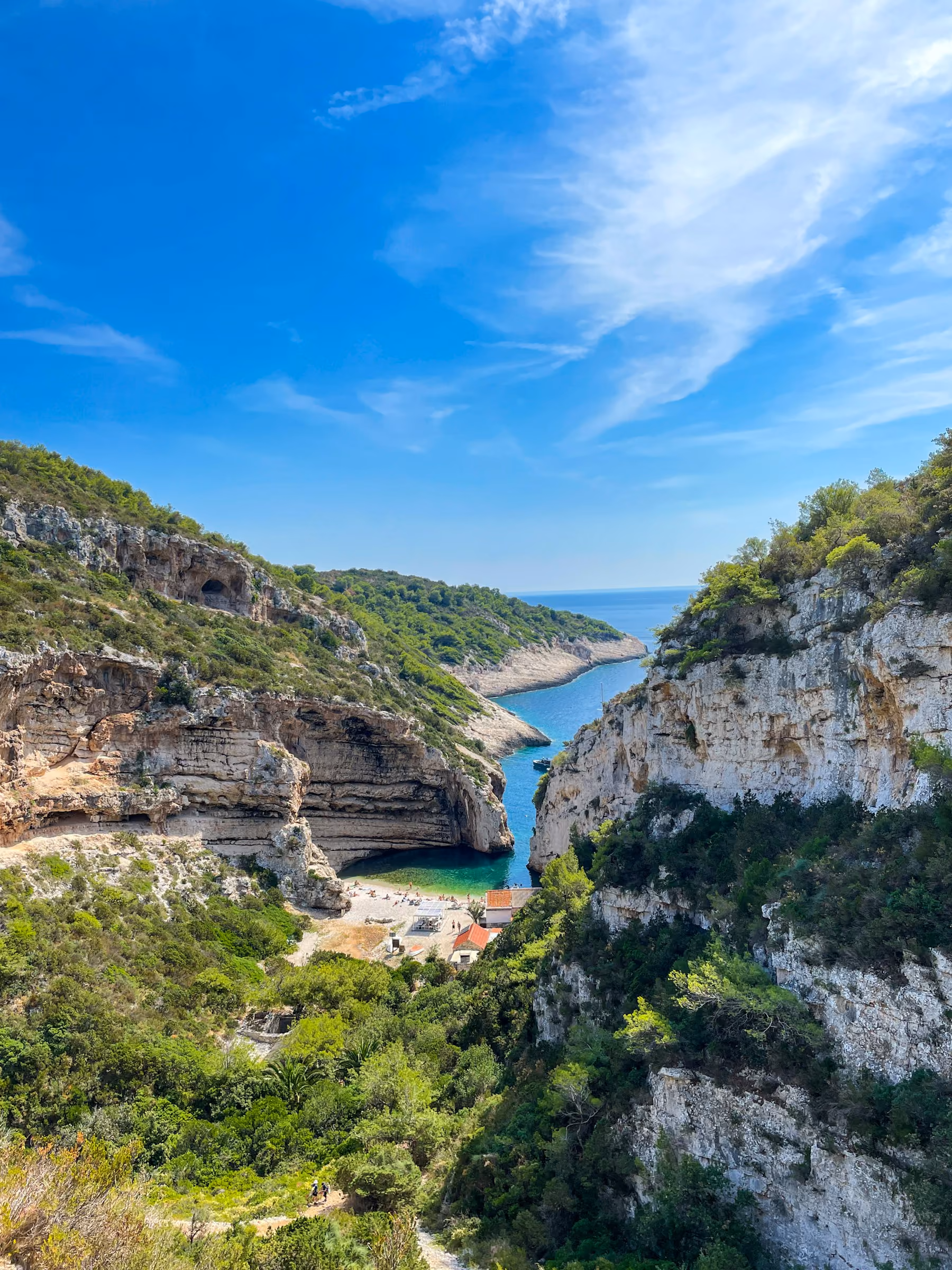 The narrow entrance to Stiniva cove on Vis, framed by tall limestone cliffs