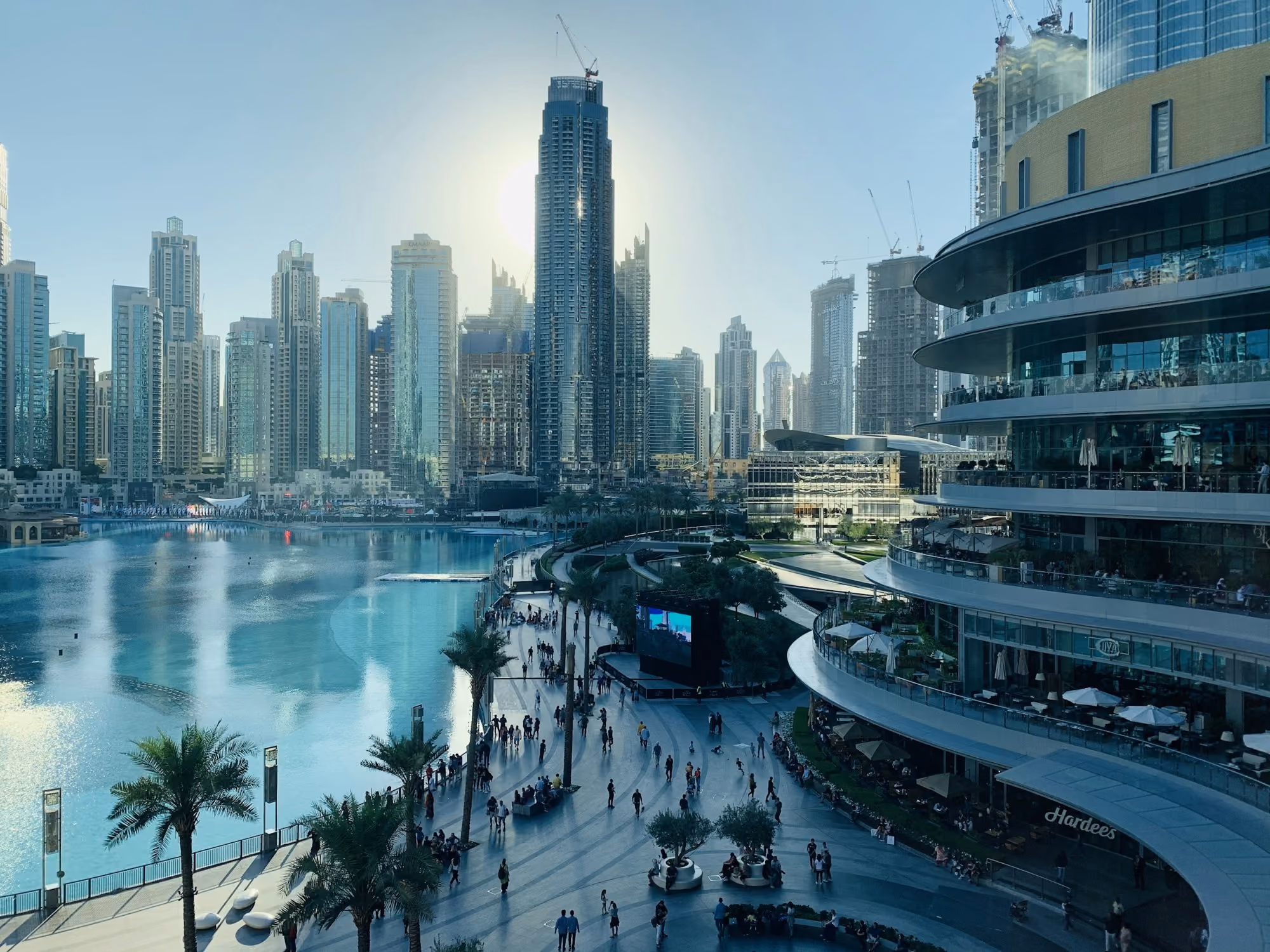 Near Address Beach Resort: people walking on the street near high rise buildings during daytime