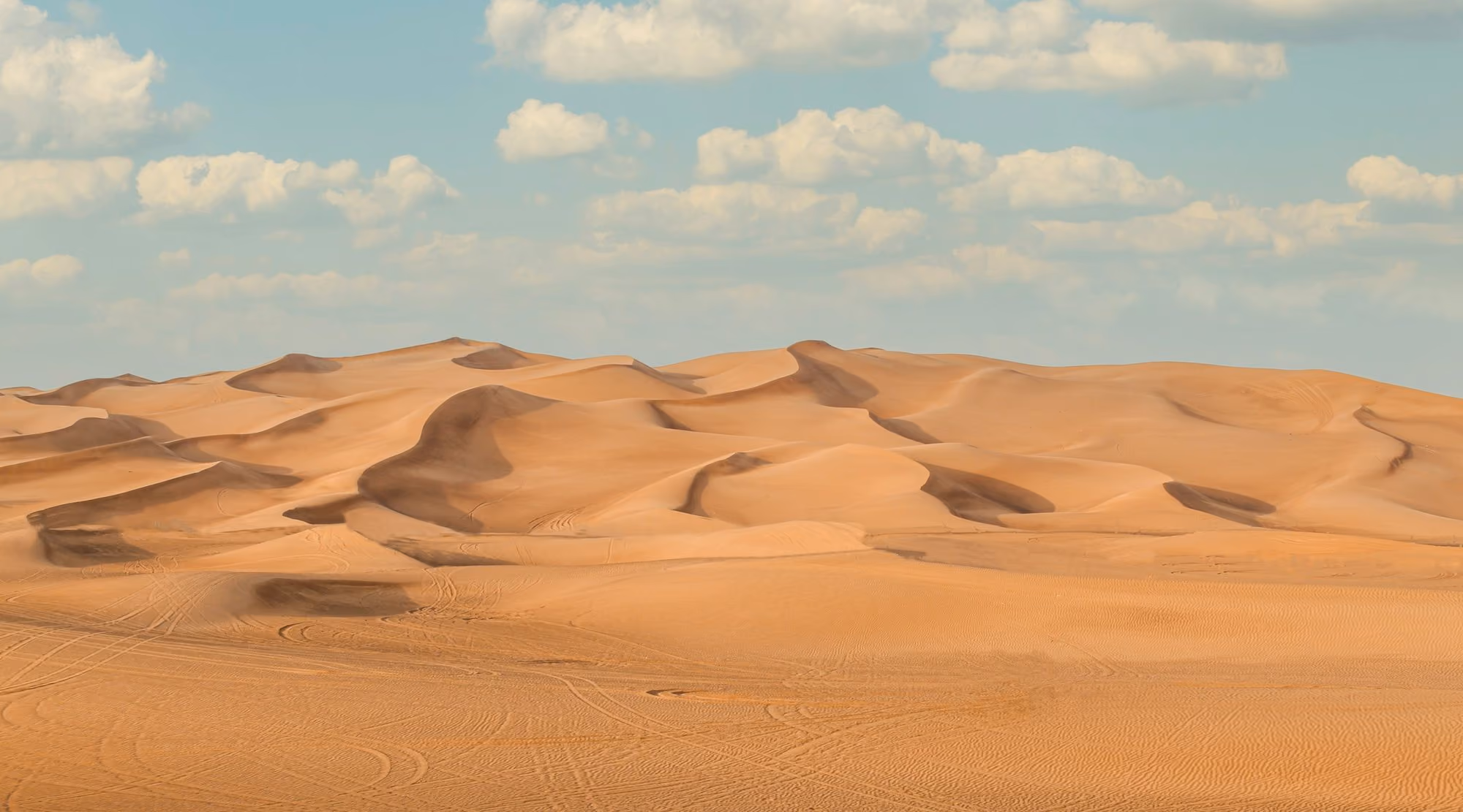 Near Bab Al Shams Desert Resort: a large group of sand dunes under a blue sky