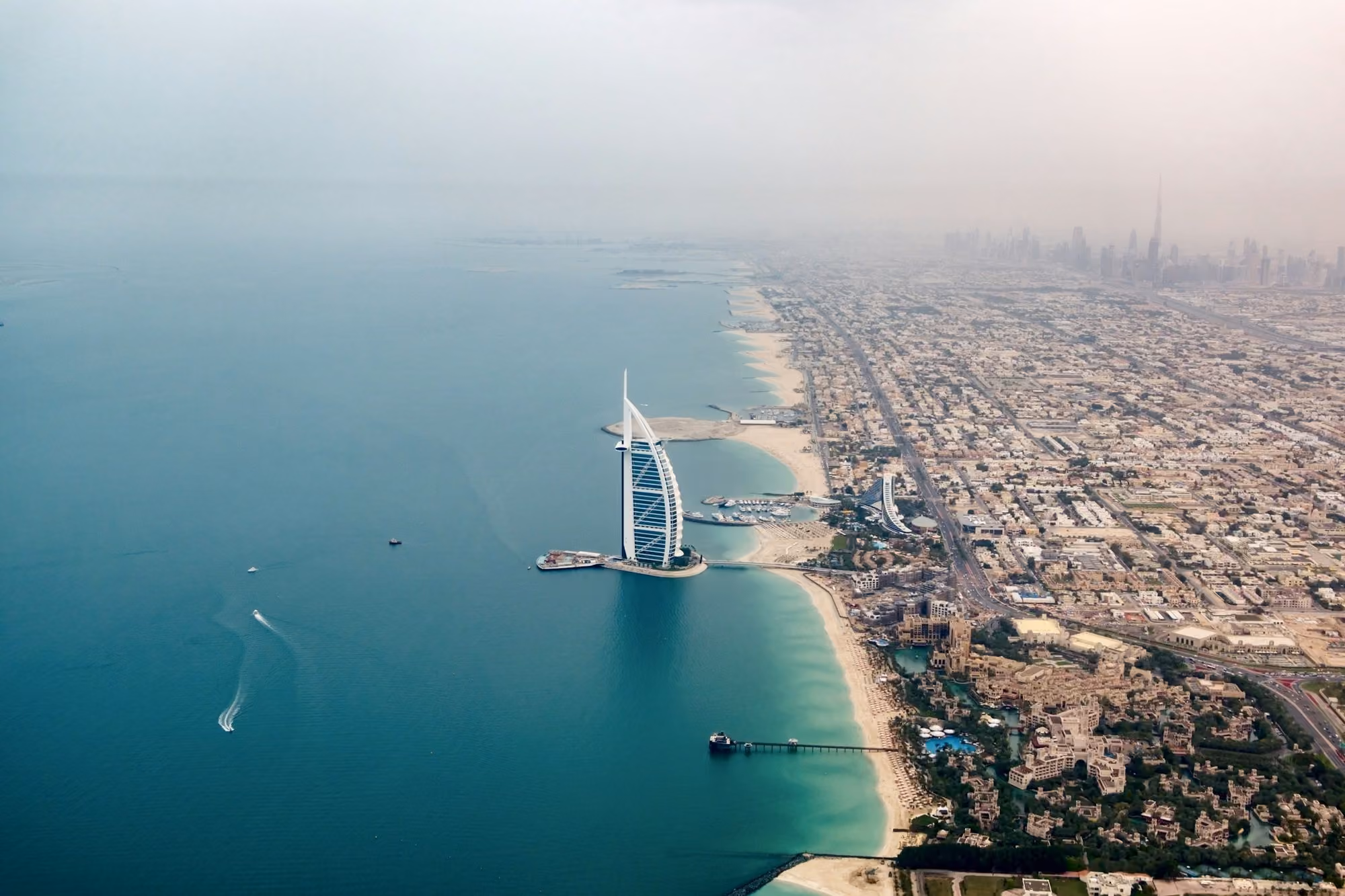 Near Bvlgari Resort Dubai: an aerial view of the burj al arab in the middle of the ocean