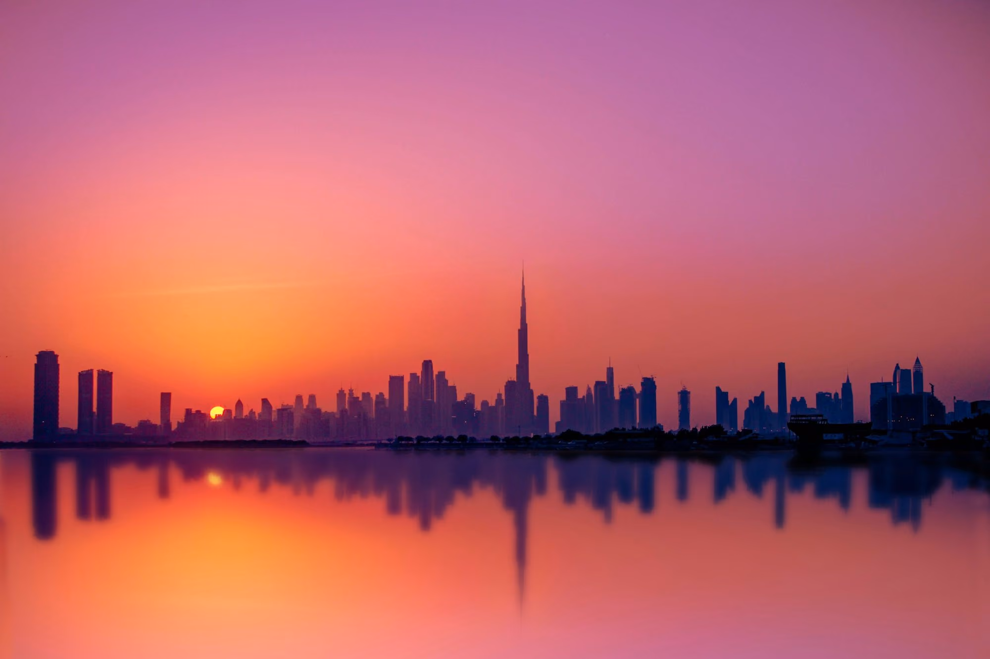 Near Four Seasons Hotel Dubai International Financial Centre: silhouette of city buildings during sunset