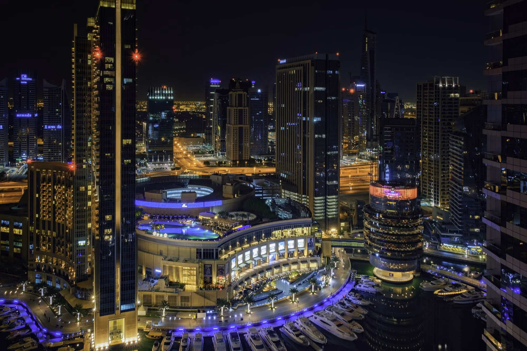 Near Grosvenor House, a Luxury Collection Hotel, Dubai: a night view of a city with a lot of tall buildings