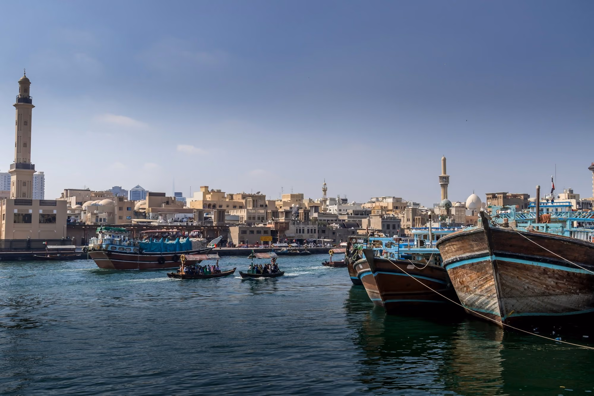 Near Palace Dubai Creek Harbour: a group of boats floating on top of a body of water