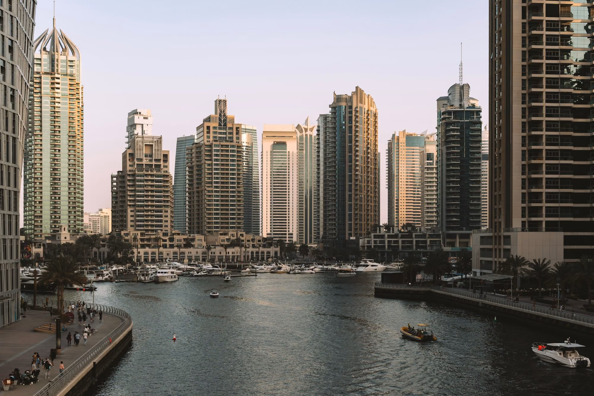 Near The Lana, Dorchester Collection: Modern skyscrapers line a tranquil canal with docked boats