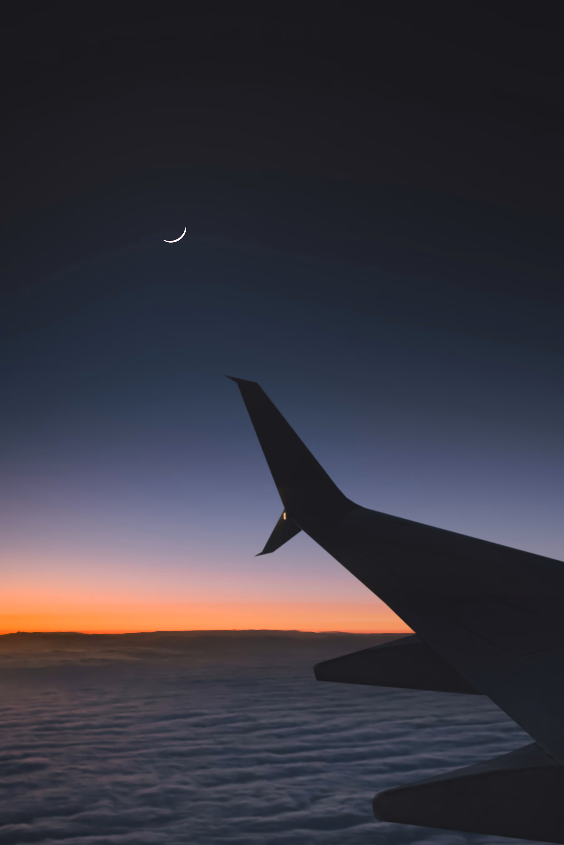 An aircraft wing against a dusk sky