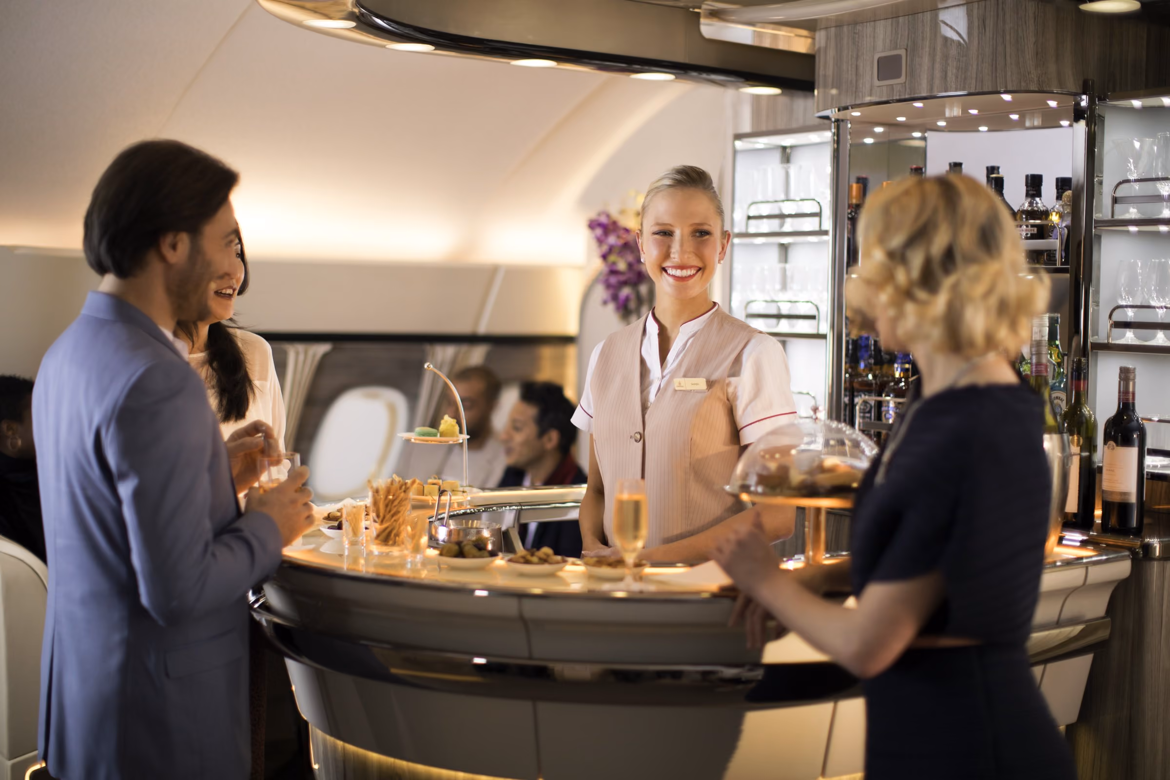 Passengers talking at the Onboard Lounge bar at the back of the Emirates A380 upper deck