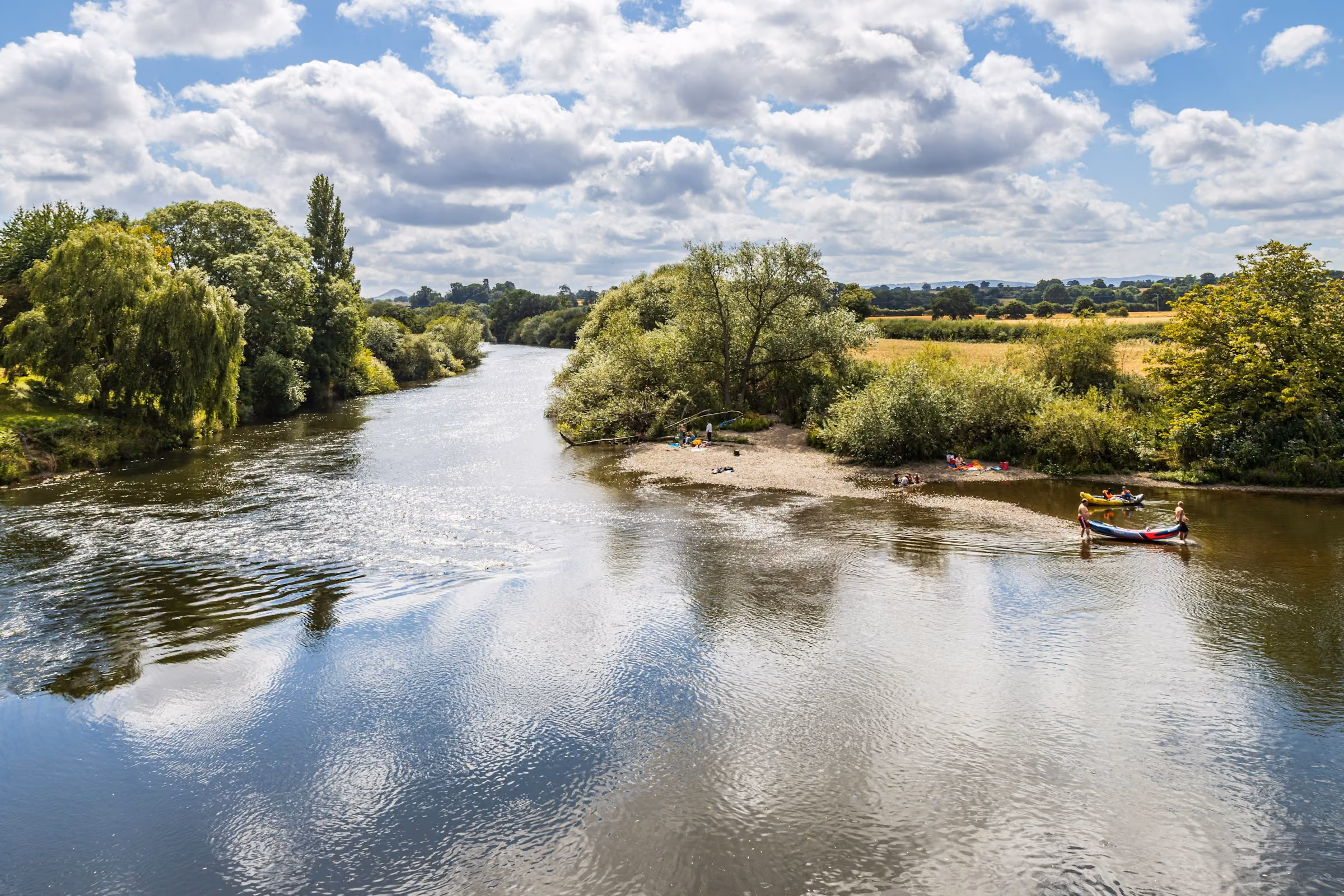 A quiet English river under a summer sky