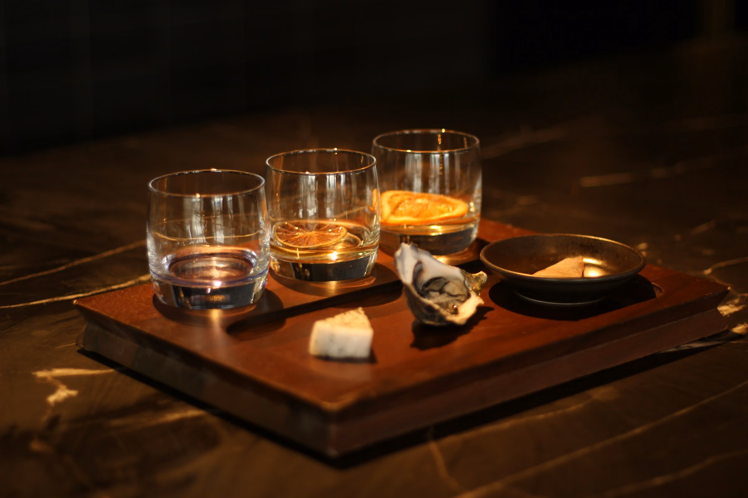 Three whiskies on a tasting board