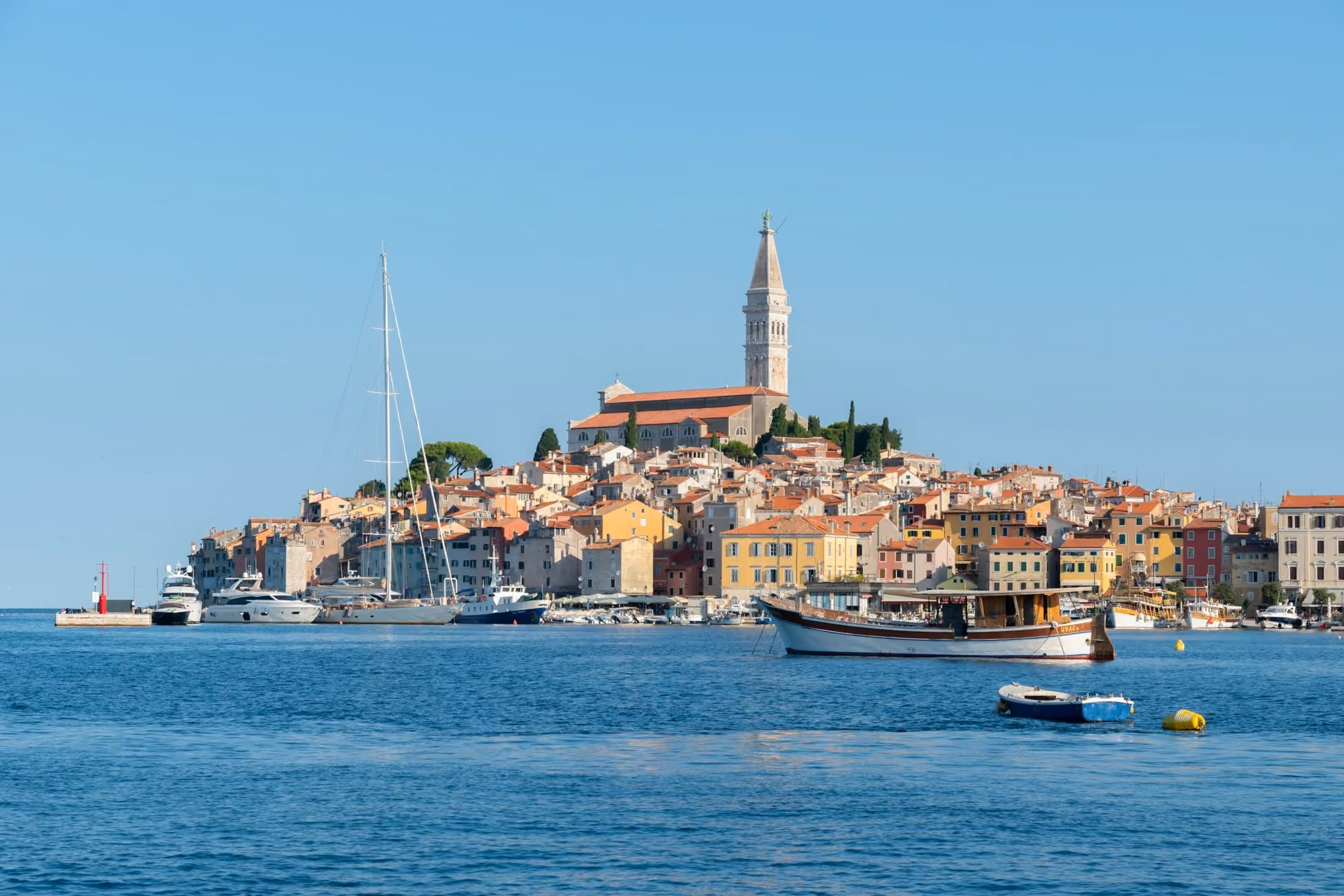 Near Grand Park Hotel Rovinj: Coastal town with colorful buildings and boats on water