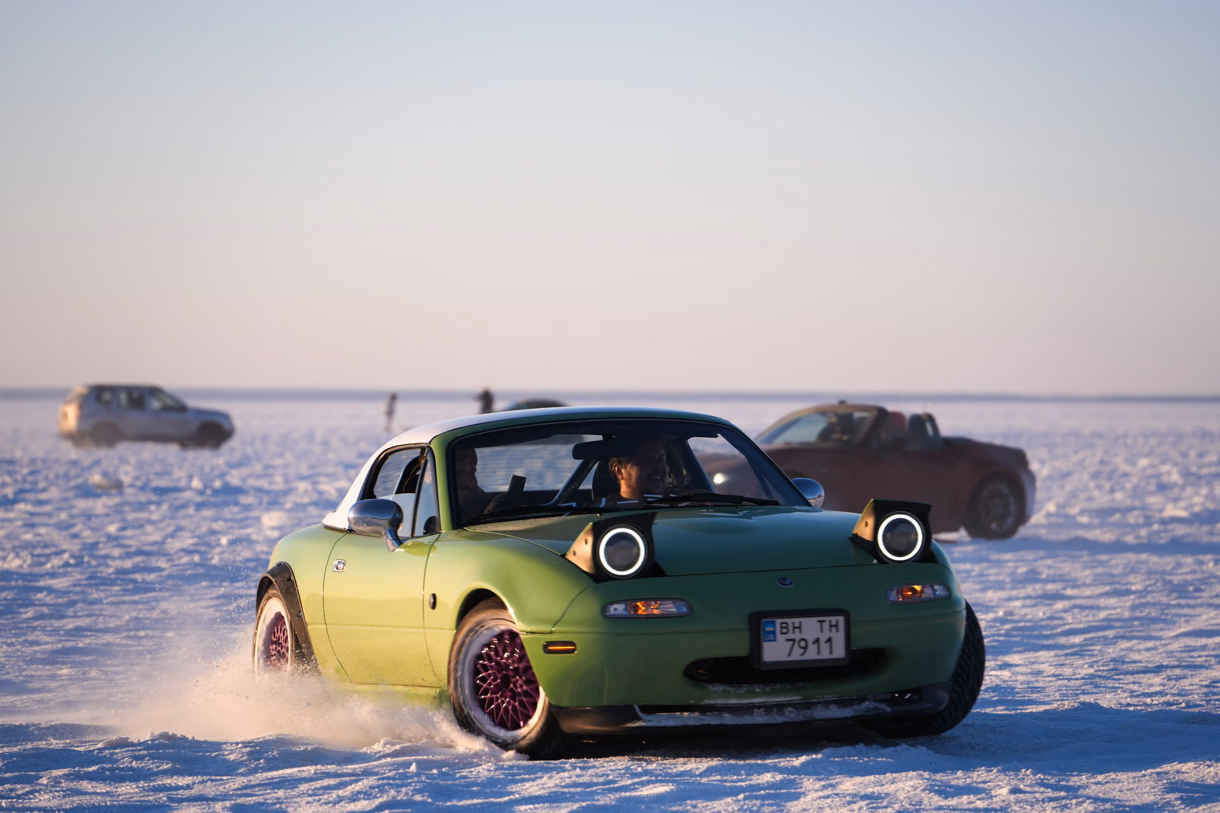A sports car sliding sideways on a frozen lake