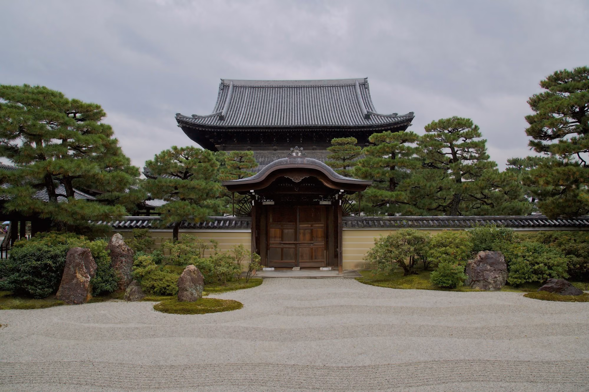 Near Capella Kyoto: brown and black temple surrounded by green trees during daytime