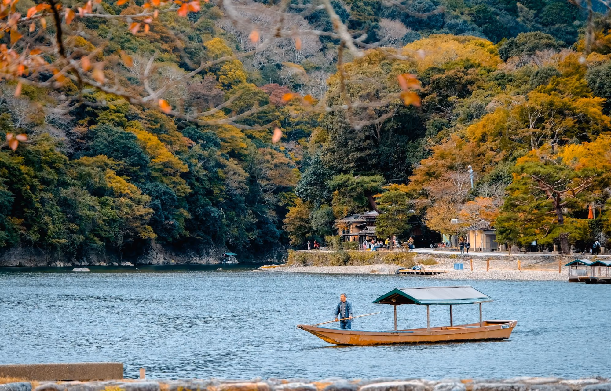 Near Hoshinoya Kyoto: person riding on boat surrounded by body of water during daytime