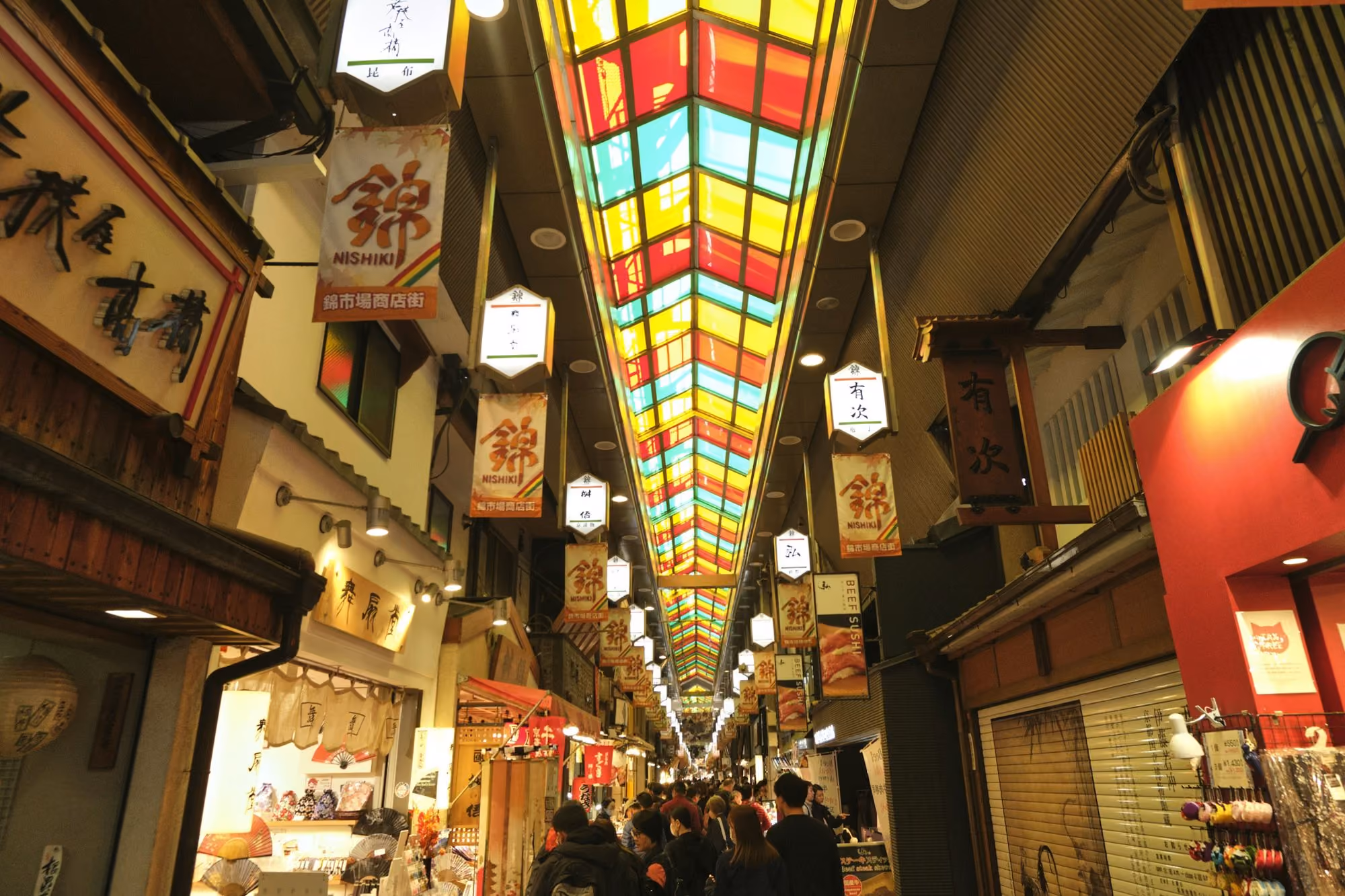 Near Kanamean Nishitomiya: a group of people walking down a long hallway