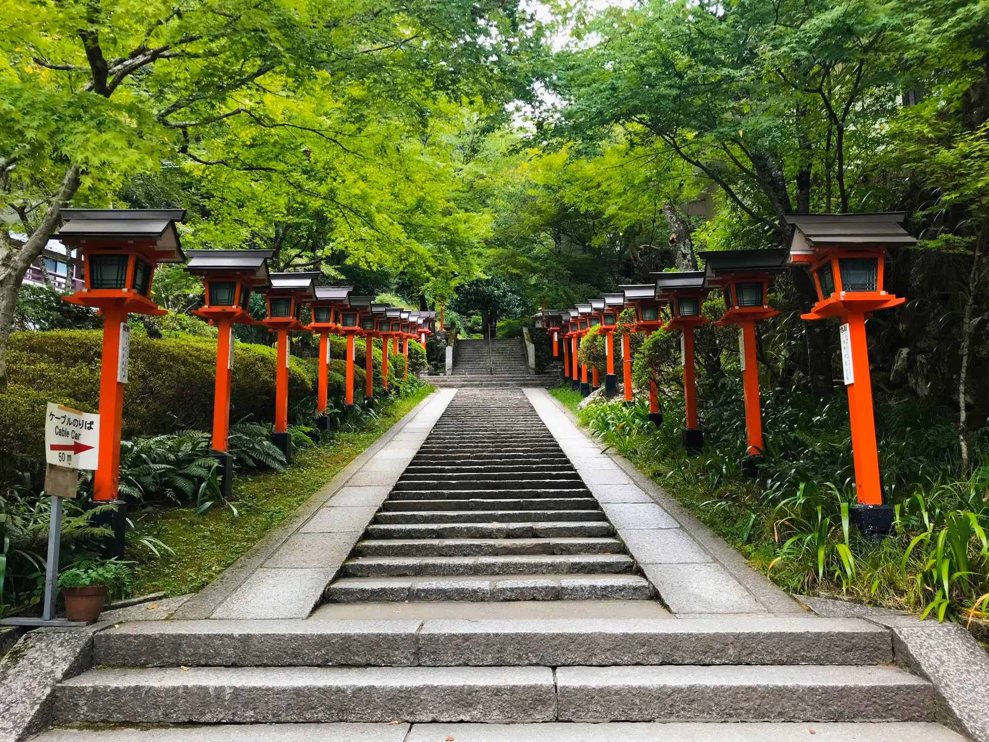 Near Kifune Ugenta: gray concrete stairs inside temple