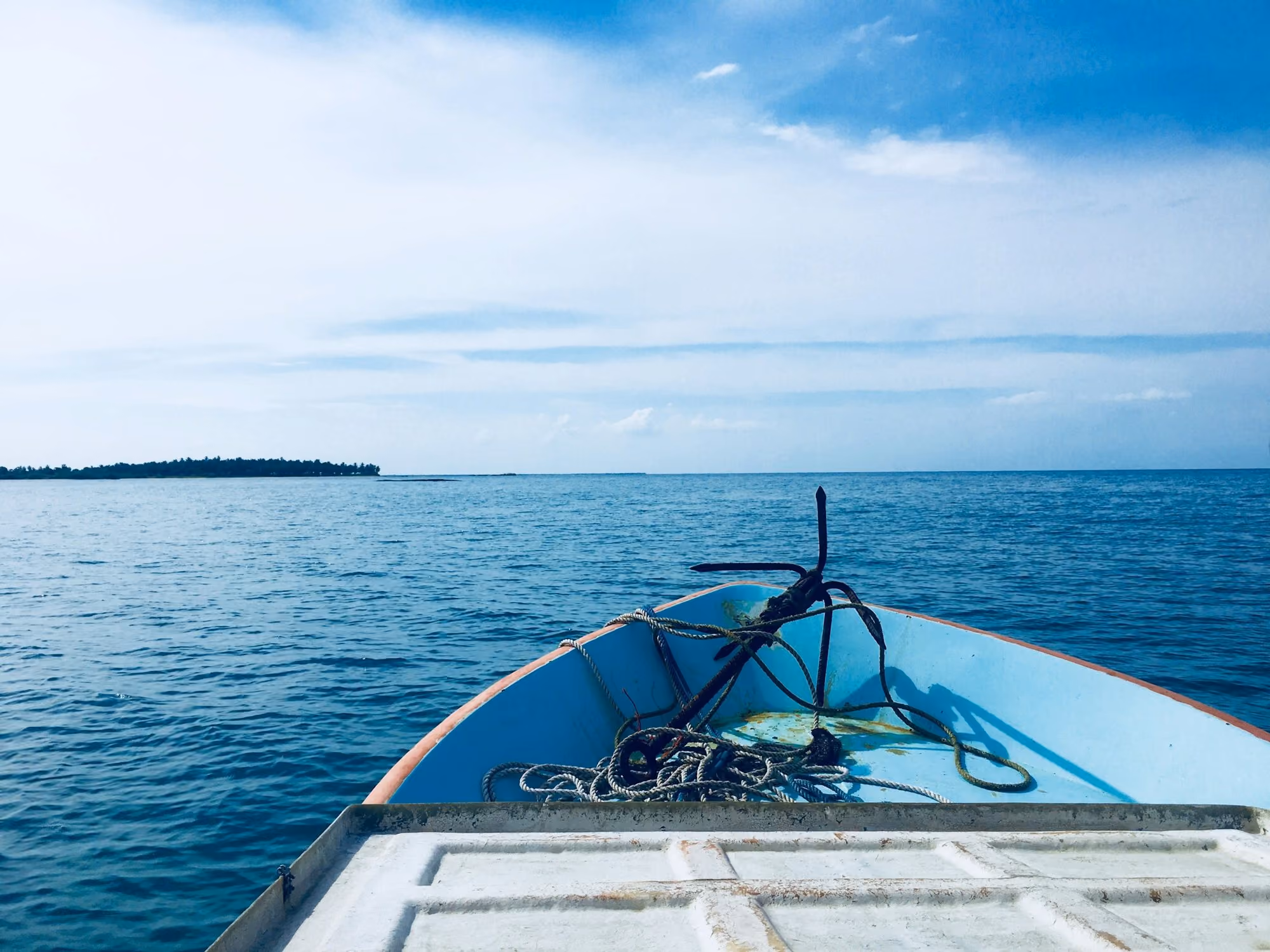 Near Karpaha Sands: a boat with a rope on the front of it in the water