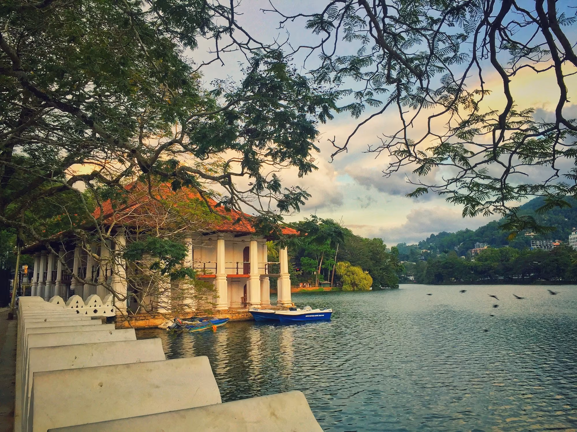 Near Santani Wellness Kandy: white and brown concrete building near body of water during daytime