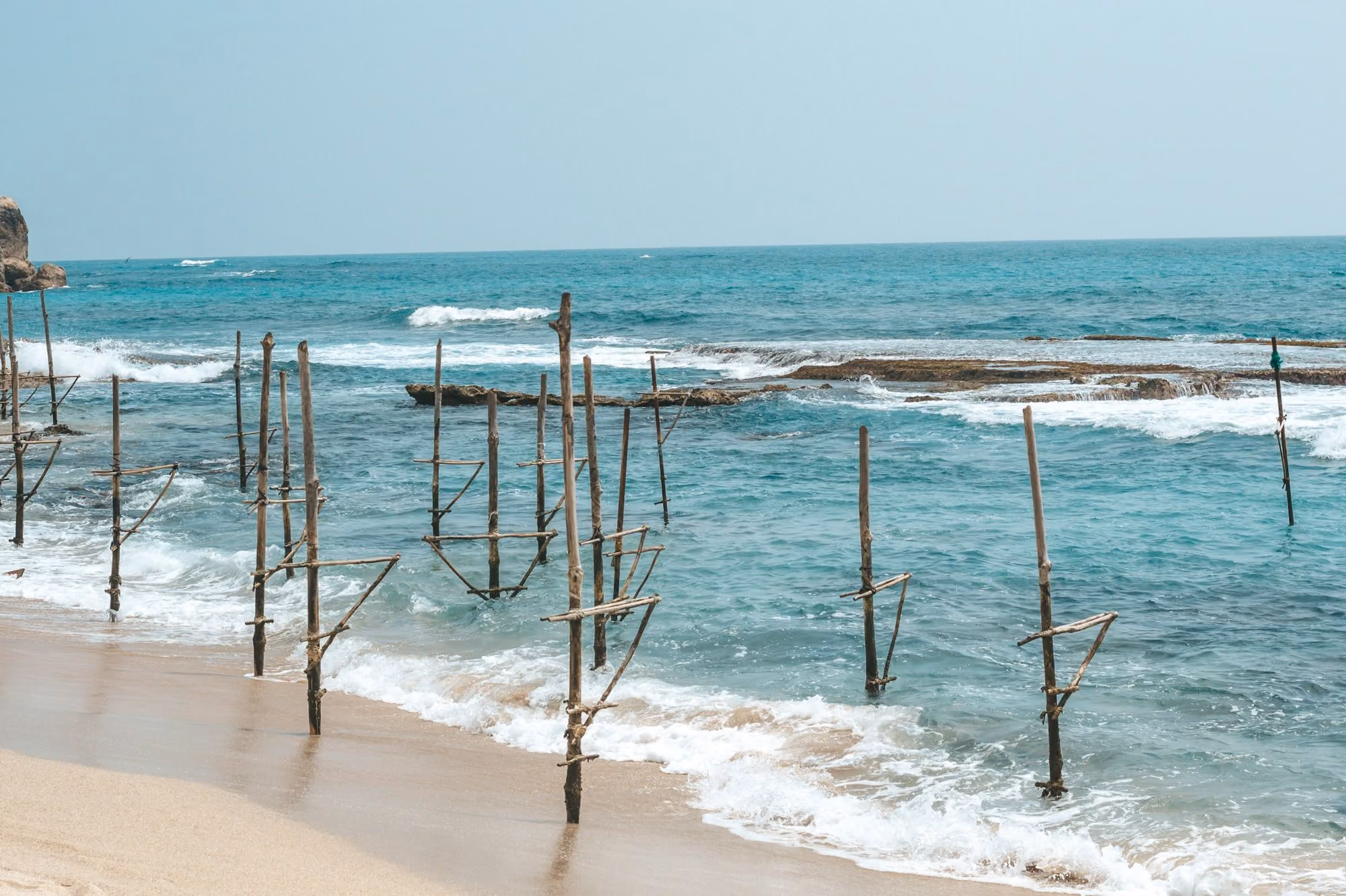 Near Villa Sielen Diva: a beach with a bunch of poles sticking out of the water