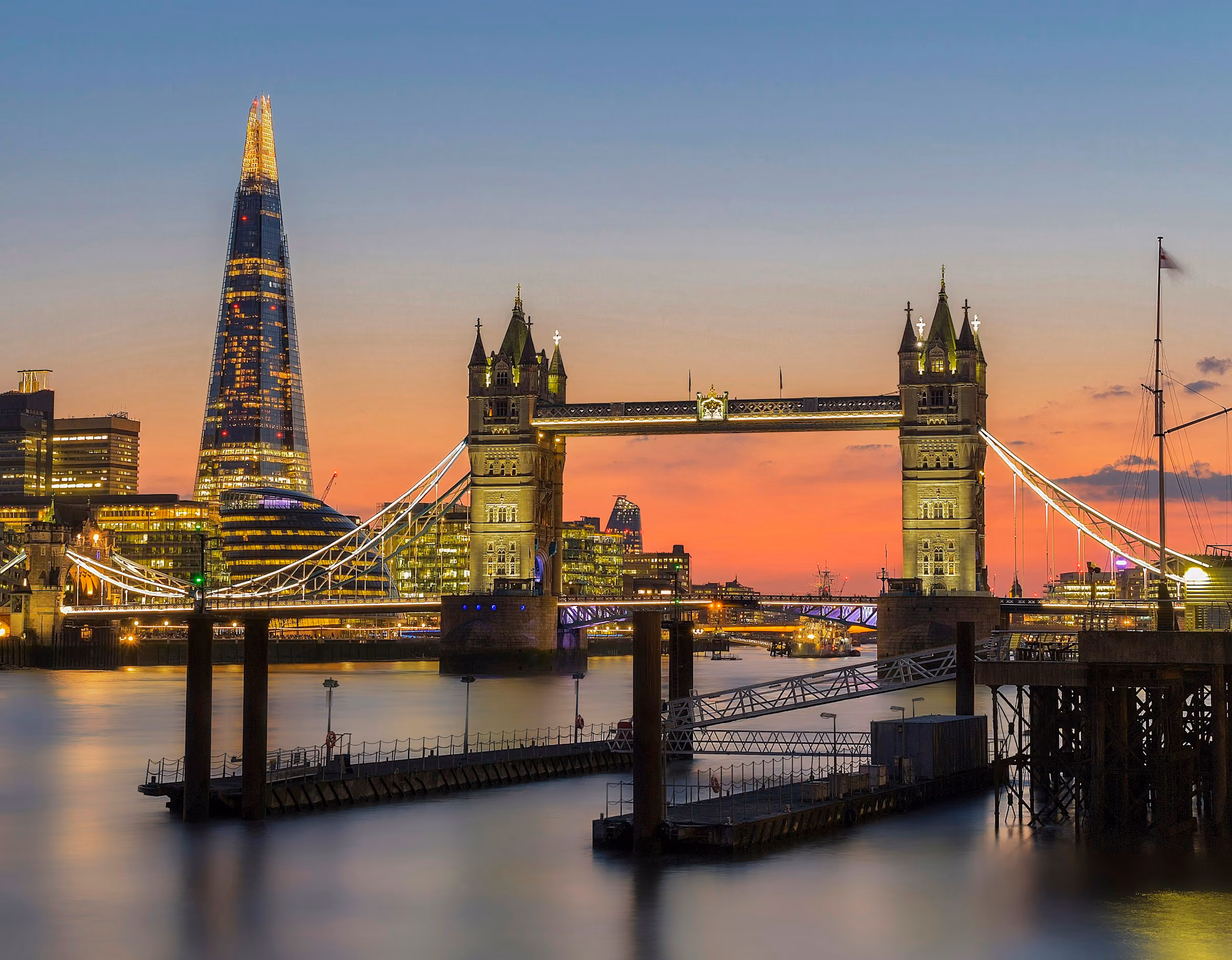 Tower Bridge and the Shard lit up at dusk over the Thames