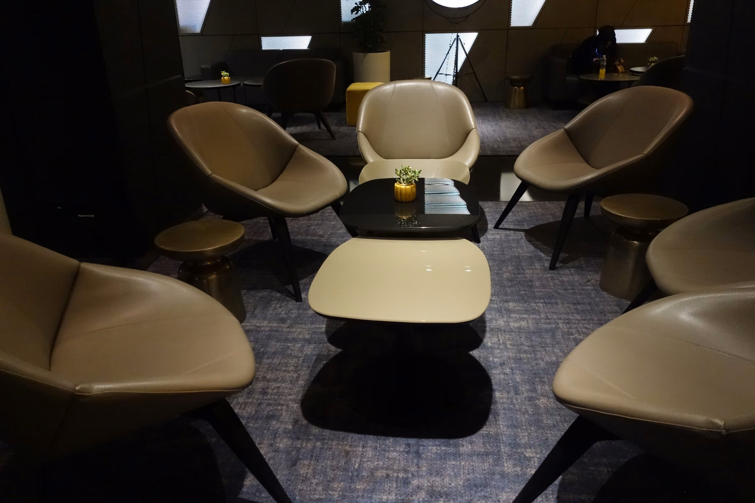 A quiet airport lounge with green velvet chairs