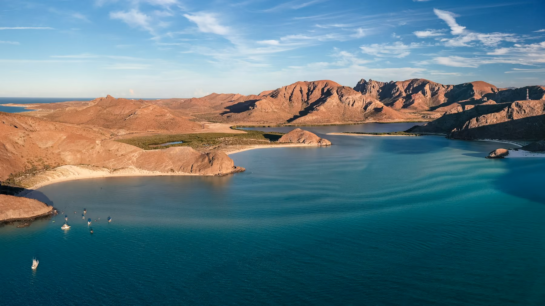 A turquoise bay ringed by red desert hills on the Baja California peninsula