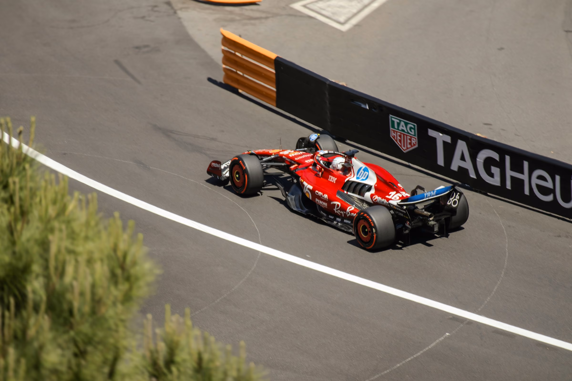 A Formula 1 car rounding a barrier-lined corner in Monaco