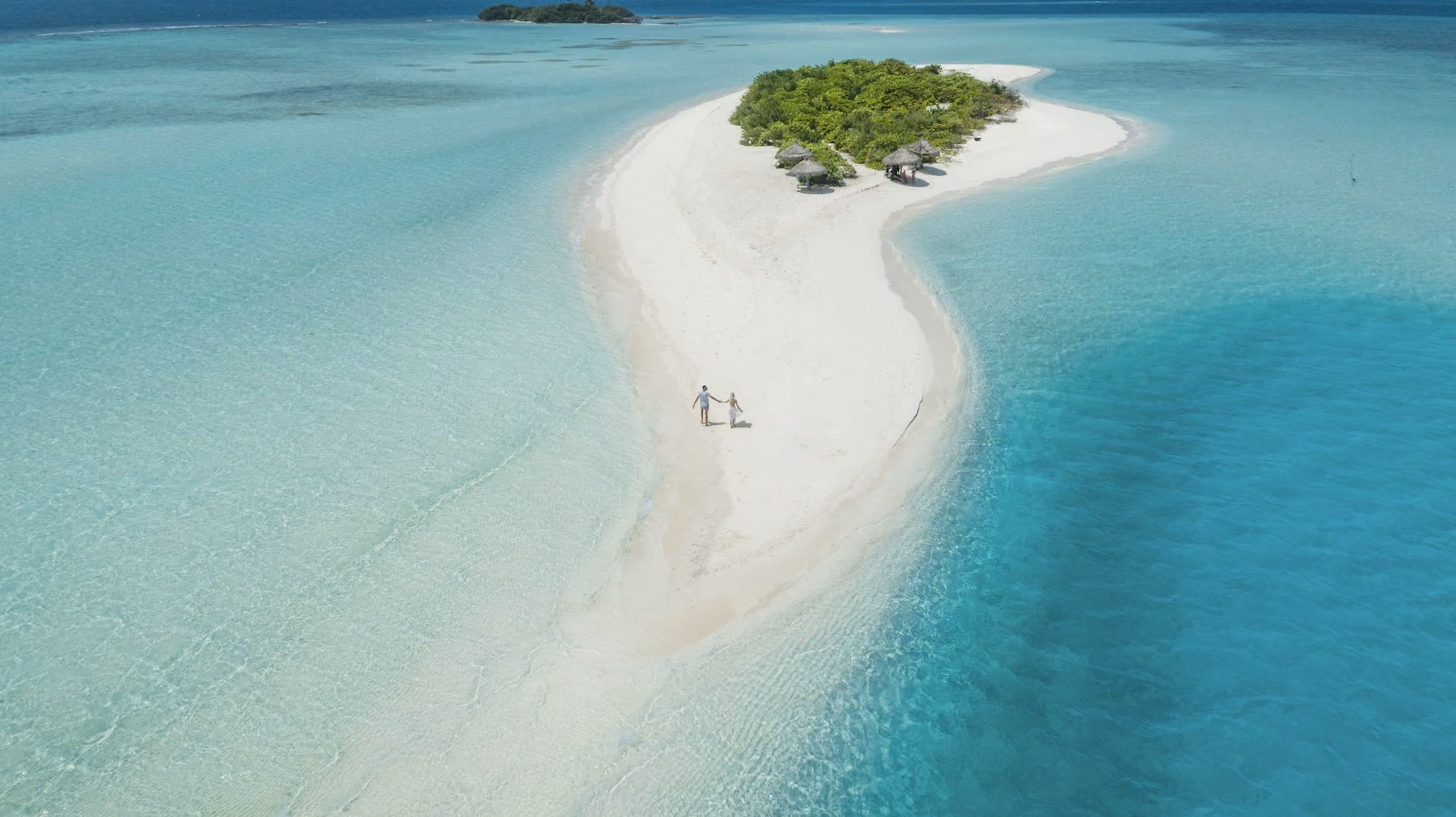 Near Velaa Private Island: two person walking on islet during daytime