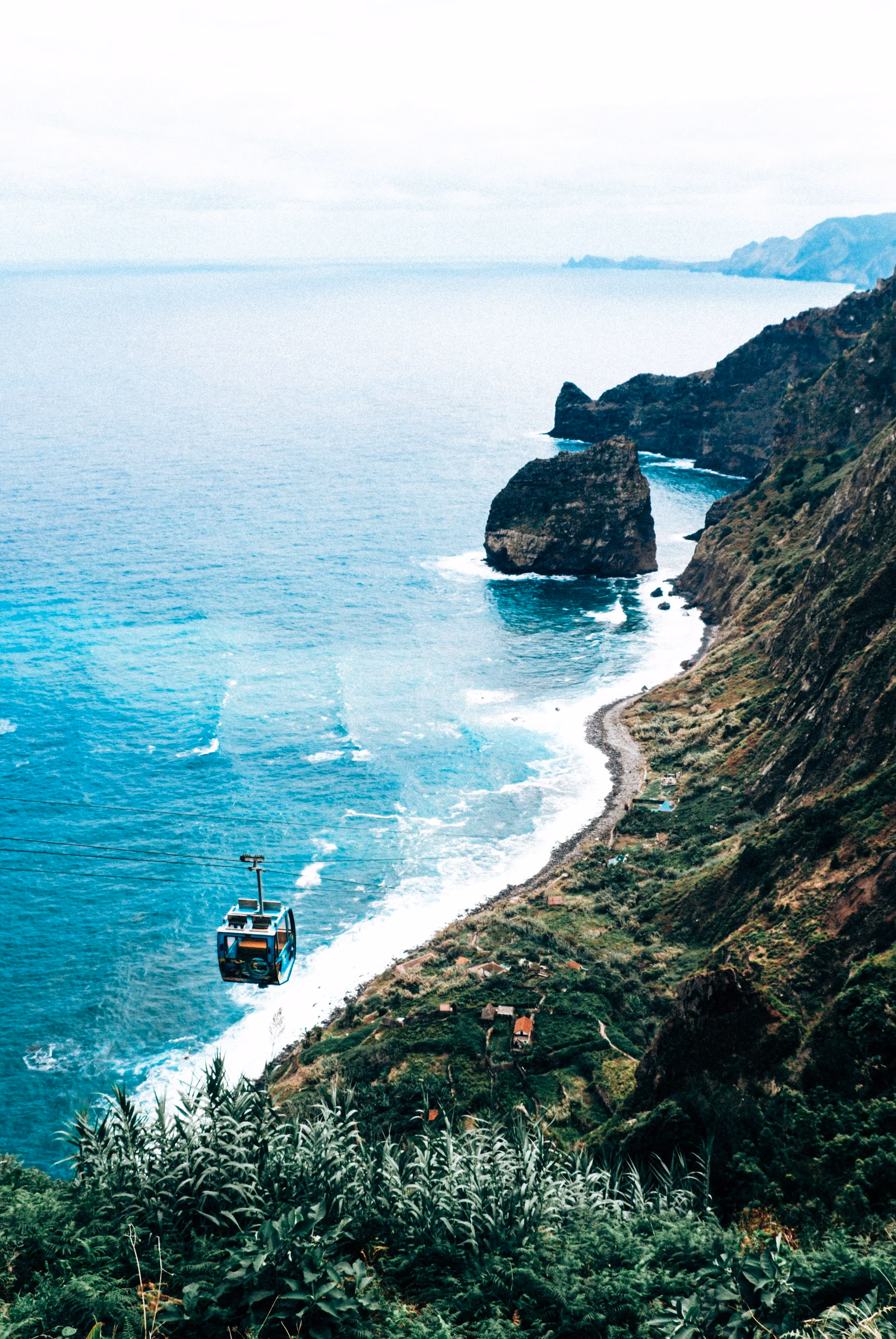 A boat off Madeira's cliff coast