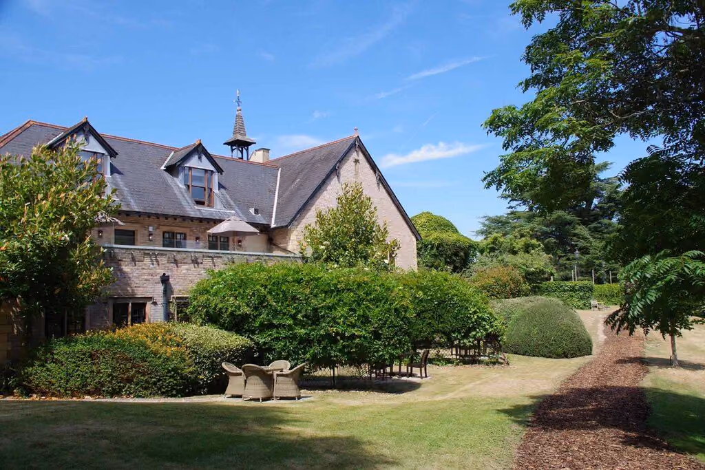 The old house at Pennyhill Park behind its gardens