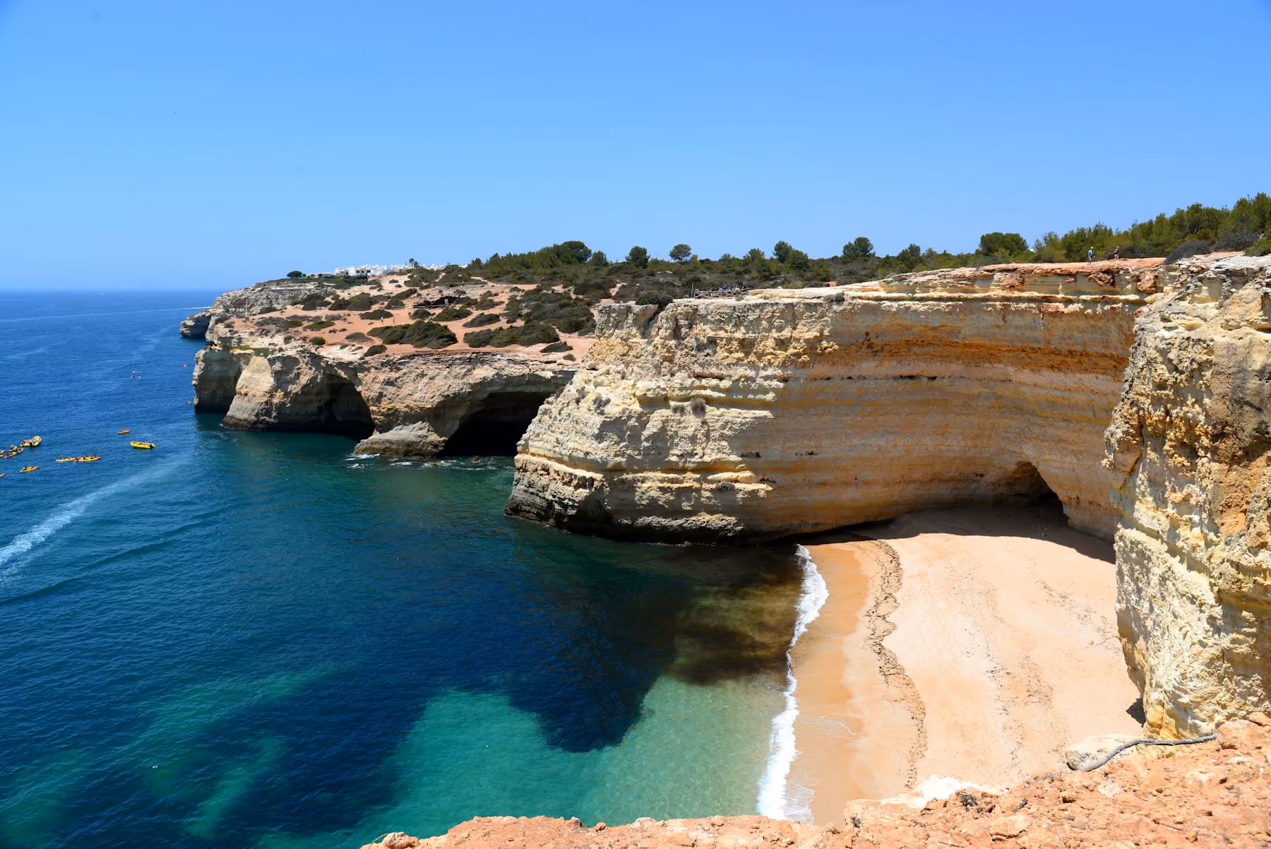Golden Algarve cliffs above a sheltered cove of clear water