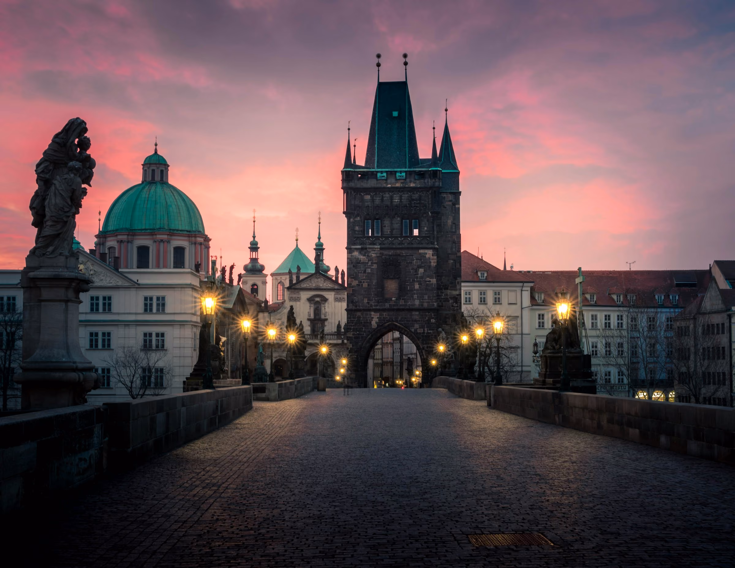 Charles Bridge at dusk, statues and the bridge tower