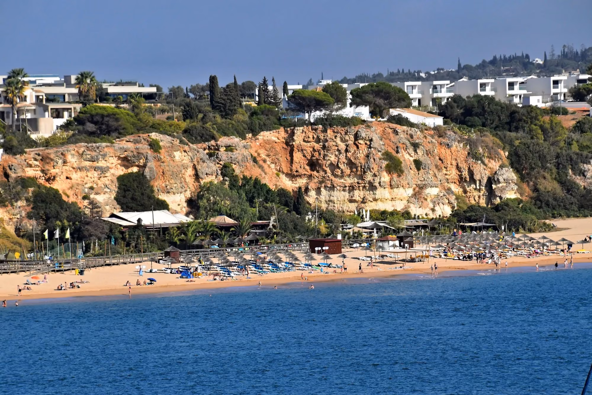 Near Bela Vista Hotel & Spa: Beach with umbrellas and buildings on cliff above cliffside cliff