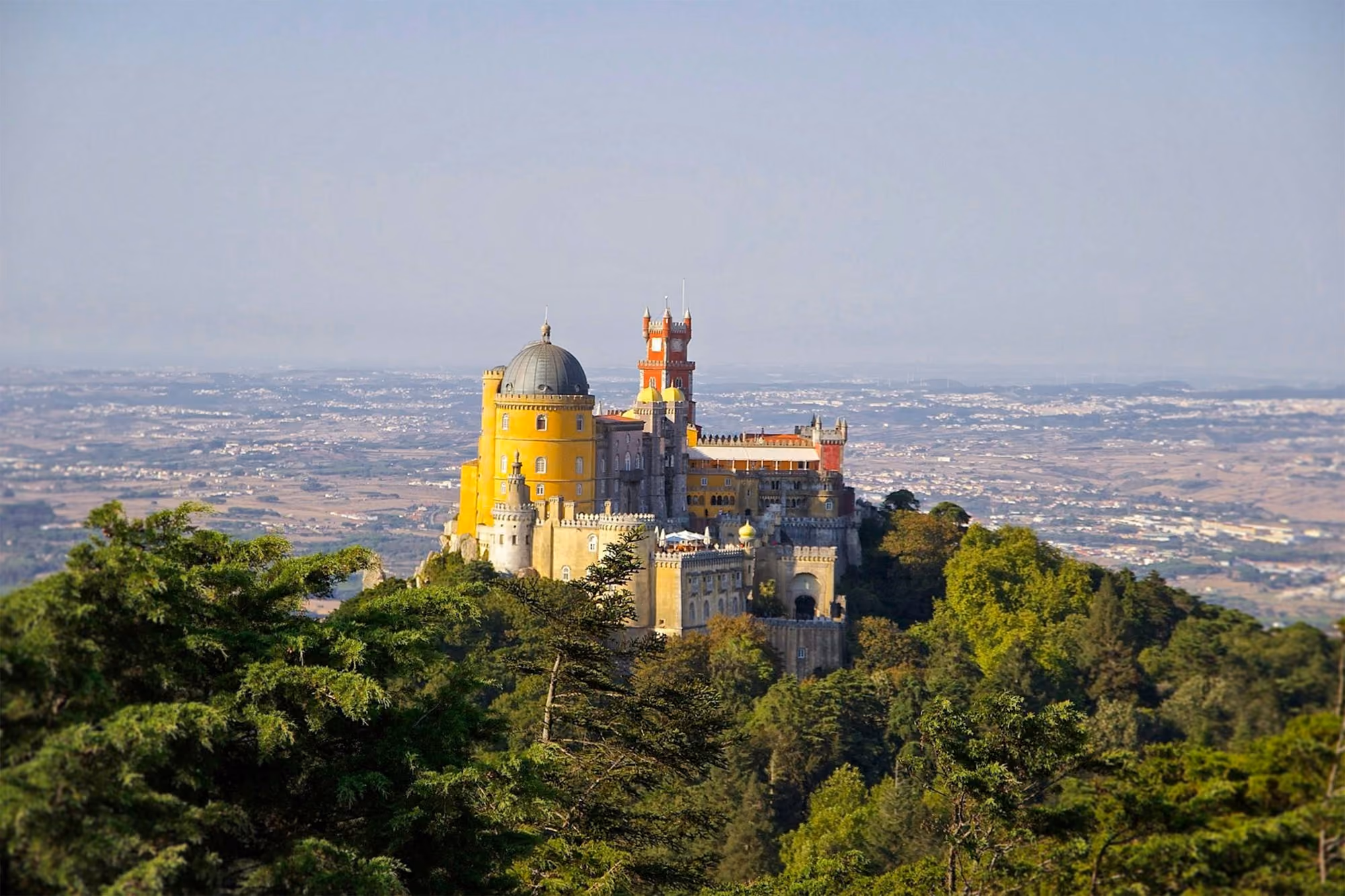 Near Penha Longa Resort: gray and yellow castle at the top of a hill
