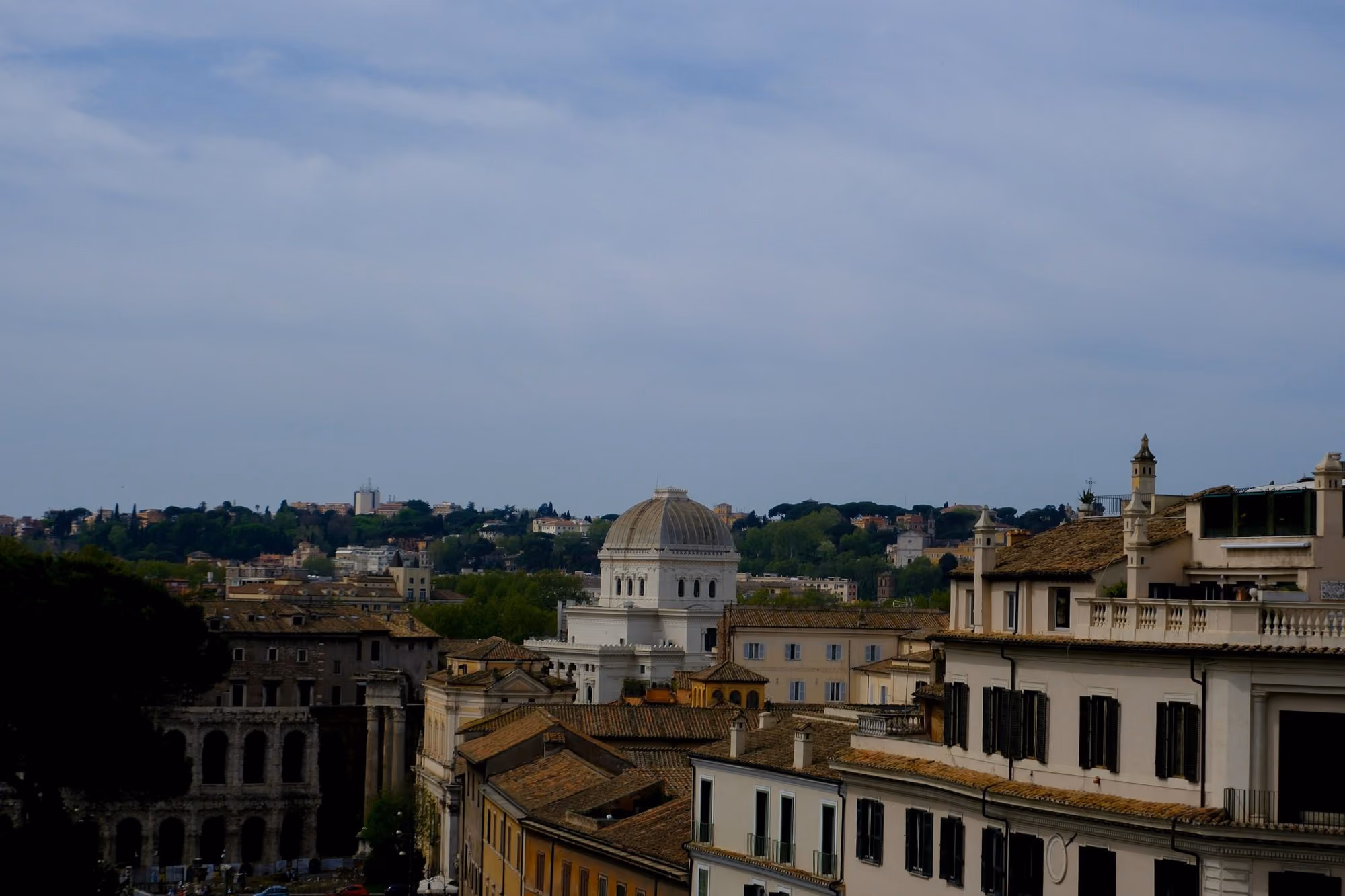 Near Bvlgari Hotel Roma: City buildings under a cloudy, blue sky