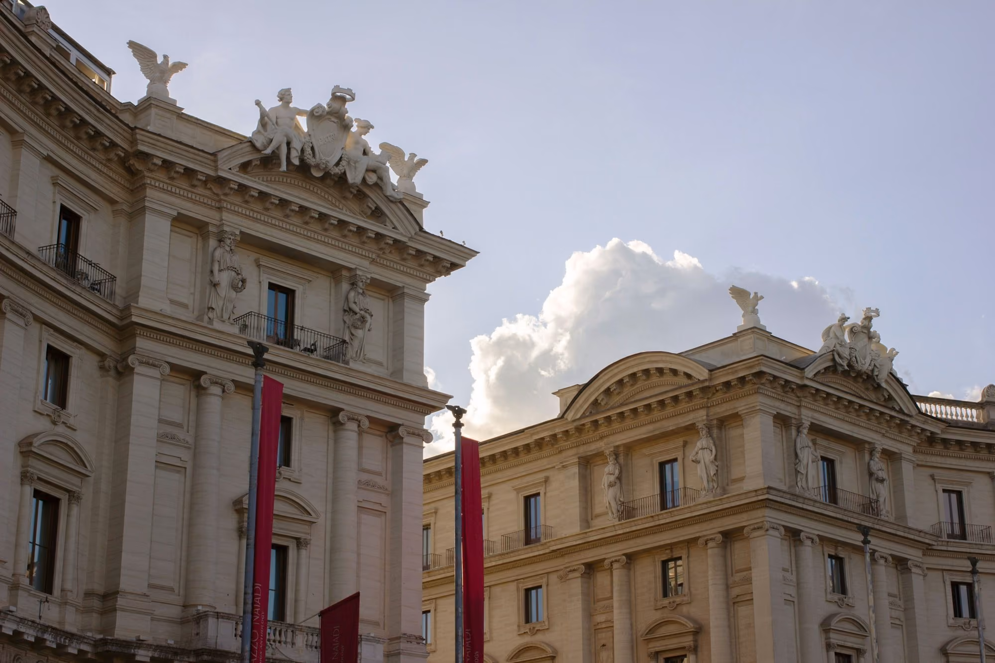 Near The St. Regis Rome: a large building with statues on top of it