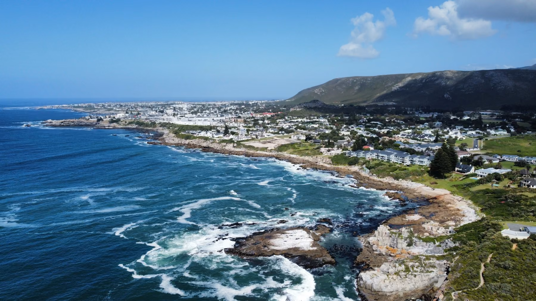 Aerial view of the rocky shoreline and town of Hermanus on Walker Bay, South Africa's whale watching coast