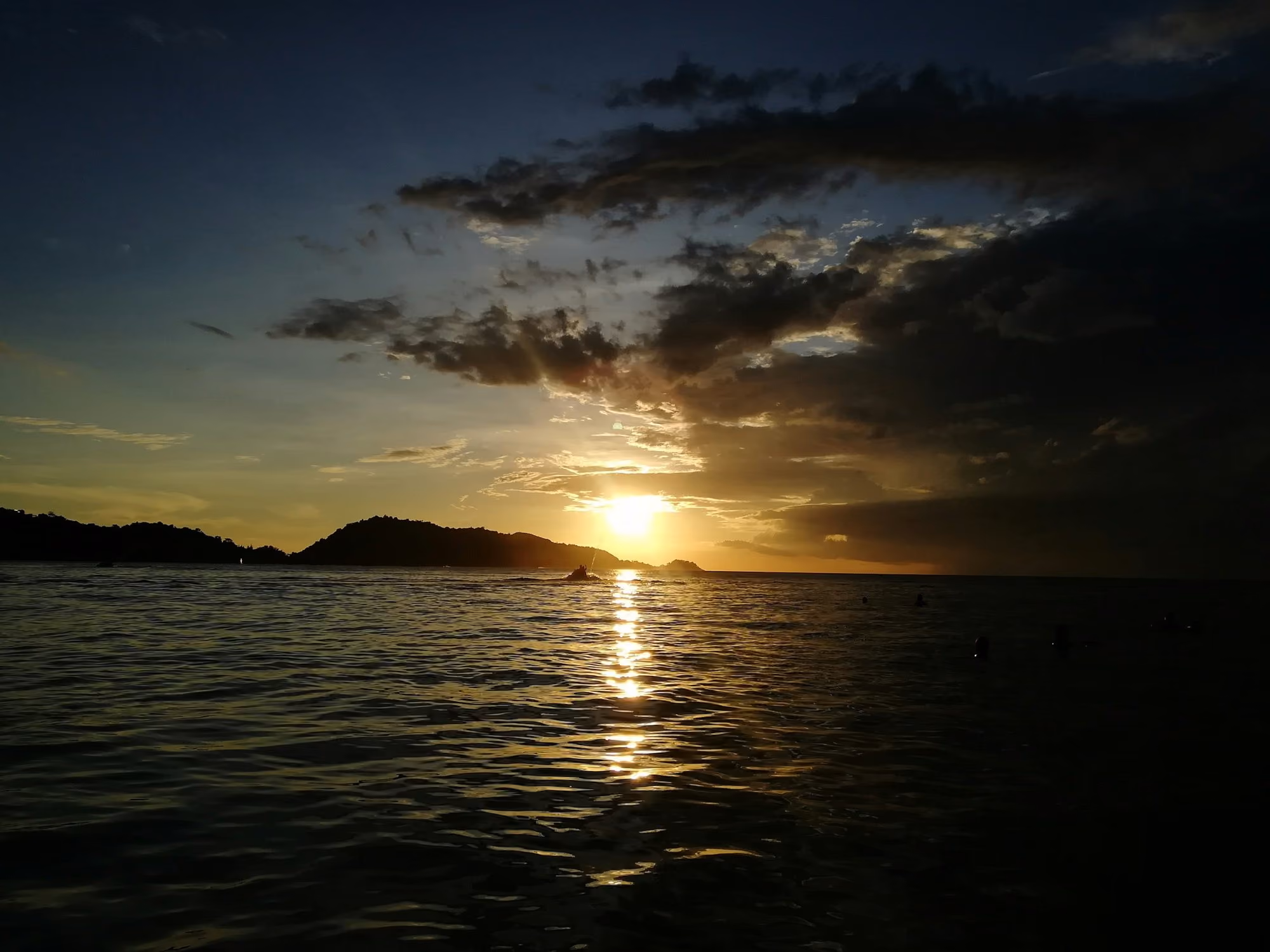 Near Trisara: body of water during sunset