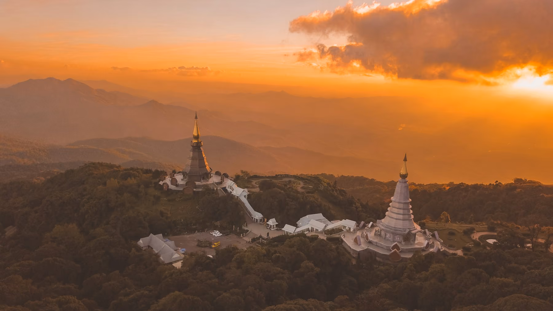 The royal chedis on Doi Inthanon at sunset above the hills of Chiang Mai province